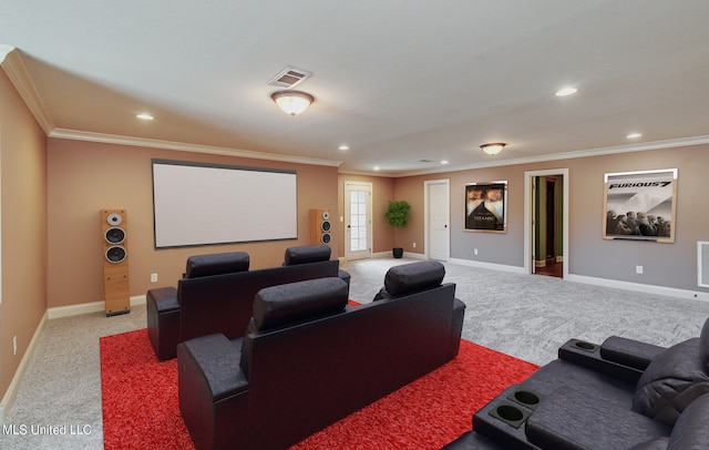 home theater room with ornamental molding and light colored carpet