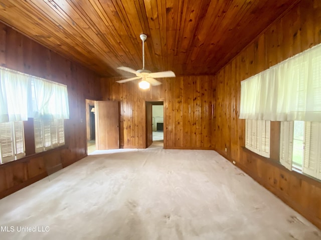 613 Georgetown St, Hazlehurst, MS 39083 - spare room featuring wooden ceiling, plenty of natural light, wood walls, ceiling fan, and carpet flooring