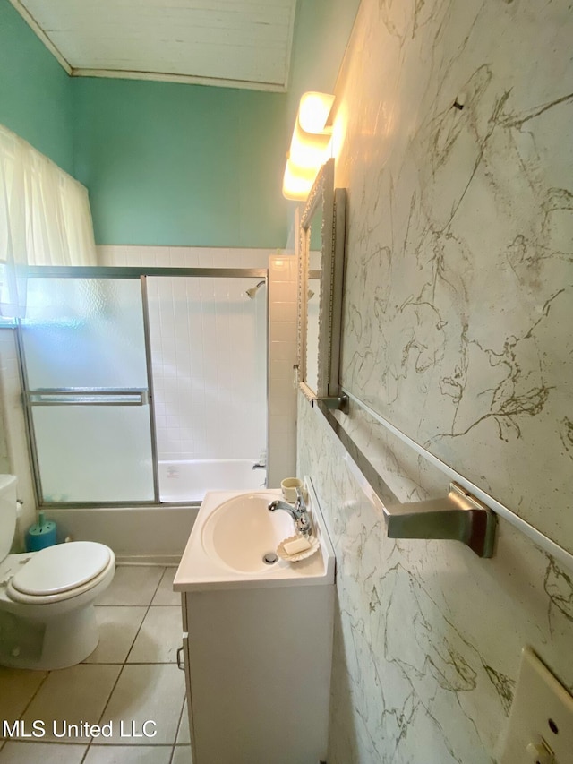 613 Georgetown St, Hazlehurst, MS 39083 - bathroom featuring vanity, toilet, bath / shower combo with glass door, and tile patterned flooring