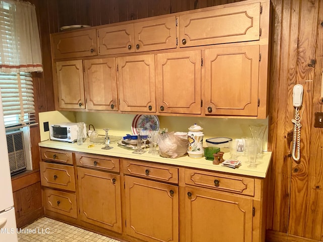 613 Georgetown St, Hazlehurst, MS 39083 - kitchen featuring light countertops, wood walls, and brown cabinets