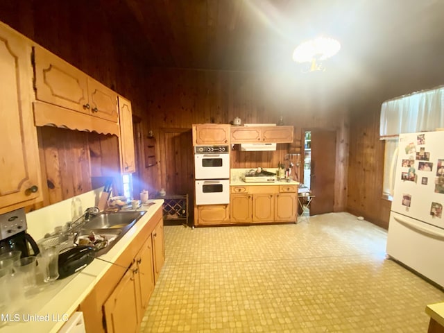 613 Georgetown St, Hazlehurst, MS 39083 - kitchen with white appliances, light countertops, light floors, under cabinet range hood, and wood walls