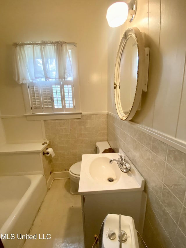 613 Georgetown St, Hazlehurst, MS 39083 - full bath featuring tile walls, toilet, vanity, a bath, and wainscoting