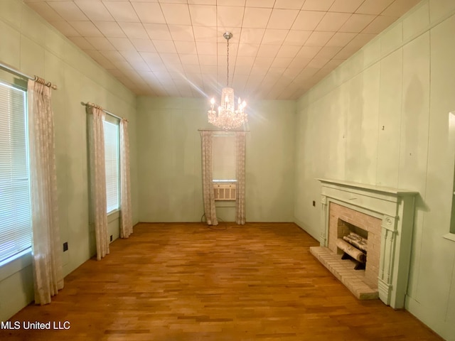 613 Georgetown St, Hazlehurst, MS 39083 - unfurnished dining area featuring a chandelier, wood finished floors, and a fireplace