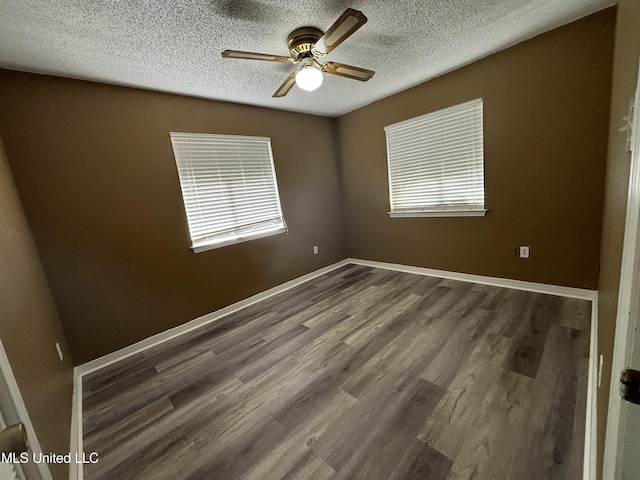 unfurnished room with a textured ceiling, ceiling fan, and dark hardwood / wood-style flooring