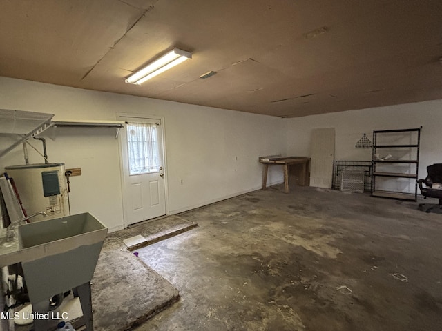 basement with water heater and a sink