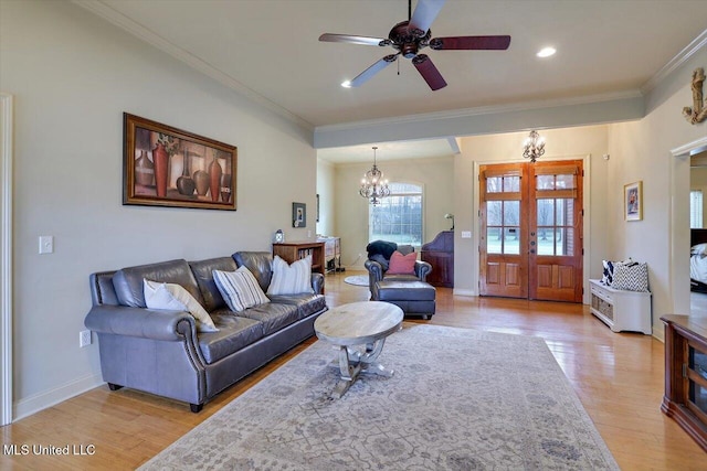 living area with crown molding, french doors, baseboards, and light wood-style floors