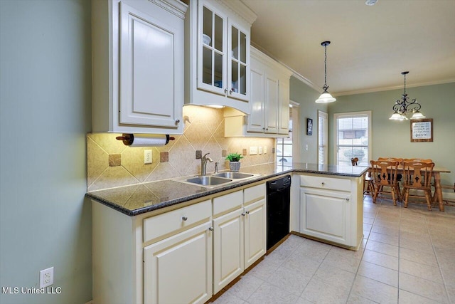 kitchen featuring a peninsula, a sink, dishwasher, tasteful backsplash, and decorative light fixtures