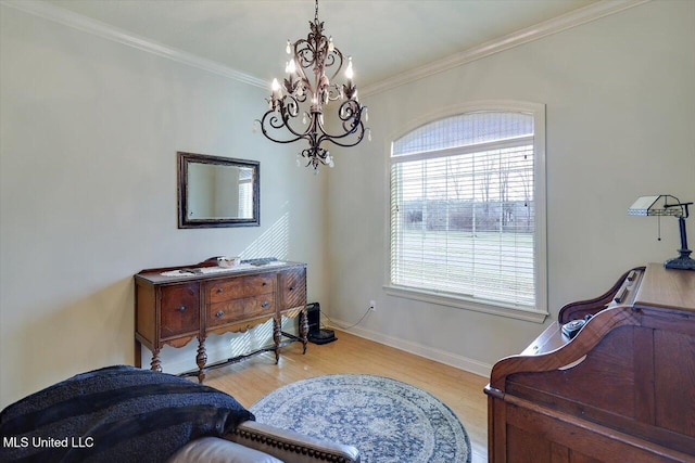 sitting room with ornamental molding, a notable chandelier, baseboards, and wood finished floors