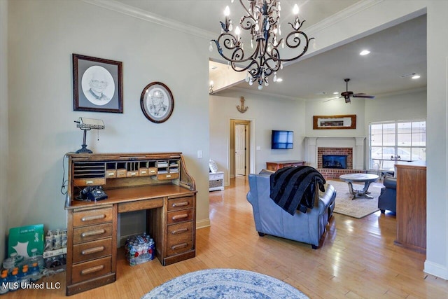 living room featuring a ceiling fan, crown molding, light wood-type flooring, a brick fireplace, and recessed lighting