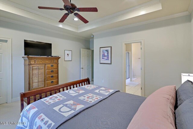 bedroom with light carpet, a tray ceiling, crown molding, and recessed lighting