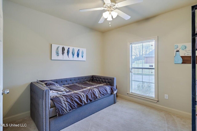 carpeted bedroom with a ceiling fan and baseboards