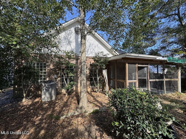 view of side of property with a sunroom