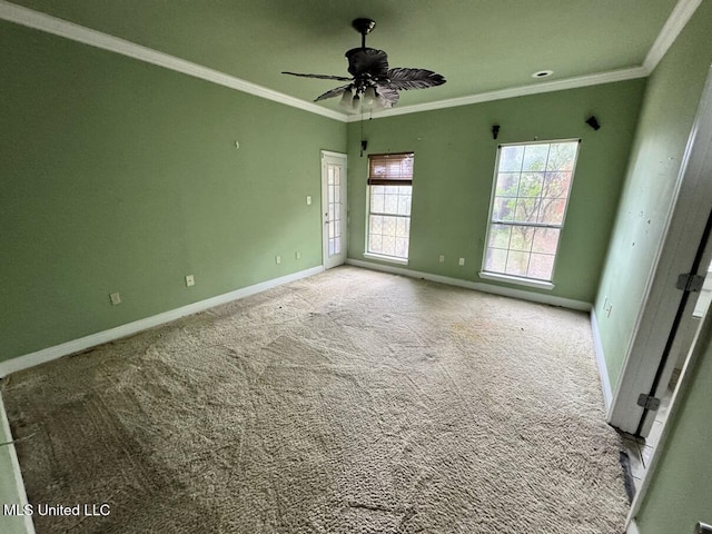 carpeted empty room with a wealth of natural light, ornamental molding, and ceiling fan