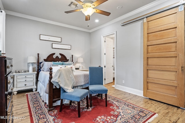 bedroom featuring ornamental molding, visible vents, baseboards, and wood finished floors