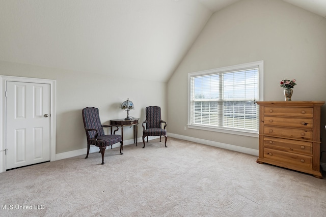 living area featuring light carpet, baseboards, and lofted ceiling