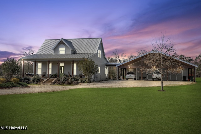 view of front of home featuring gravel driveway, a yard, covered porch, a standing seam roof, and metal roof