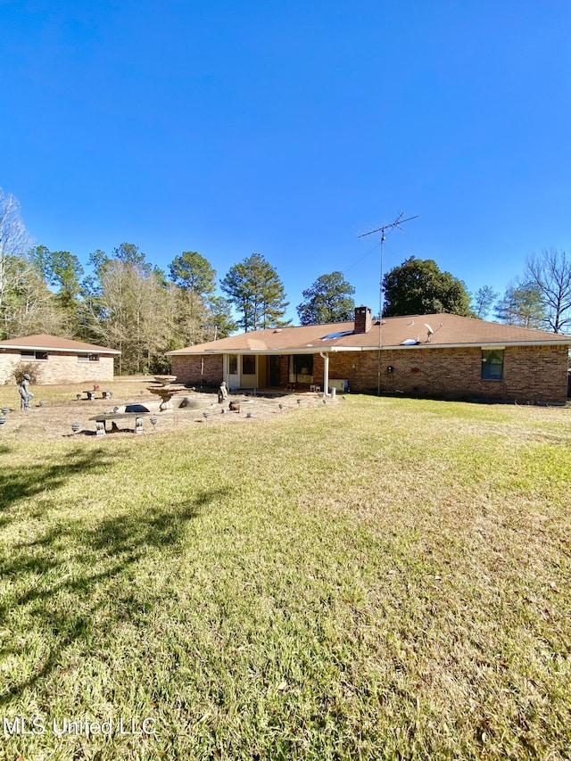 rear view of property with a lawn