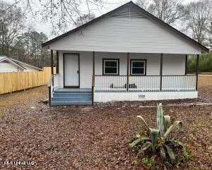 rear view of house featuring a porch