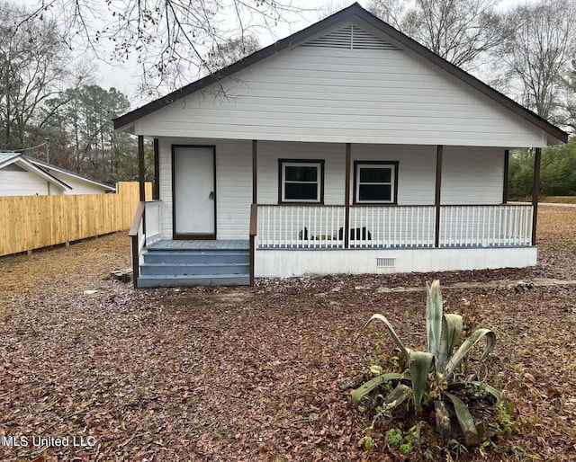 rear view of house with covered porch