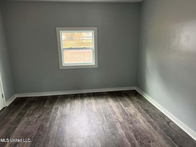 empty room with dark wood-type flooring