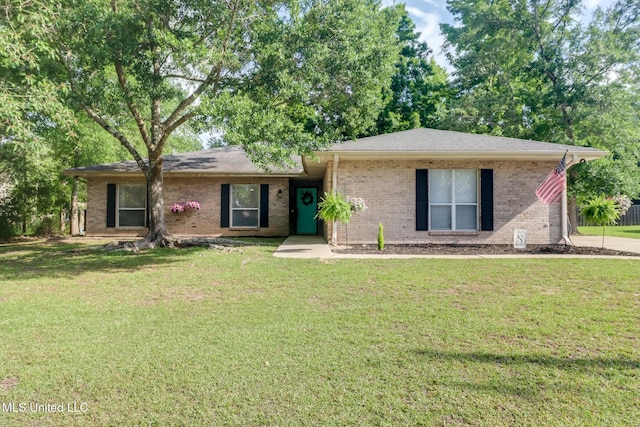 ranch-style house with a front yard and brick siding