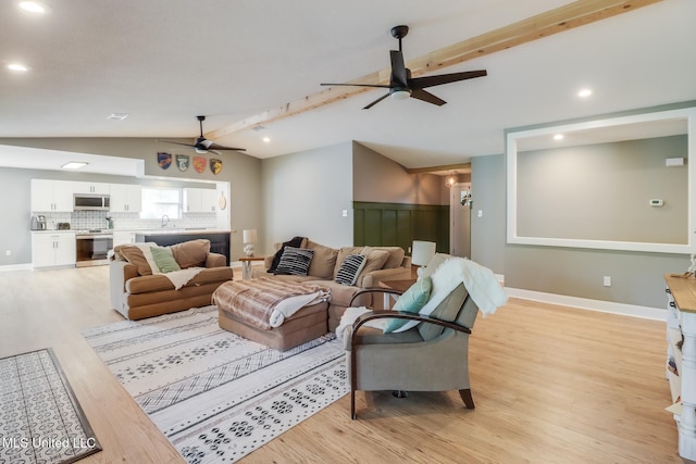 living area featuring ceiling fan, light wood-style floors, and recessed lighting
