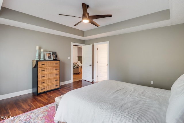 bedroom with wood finished floors, baseboards, and a ceiling fan