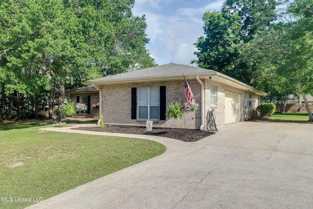 single story home with driveway, a front yard, a garage, and brick siding