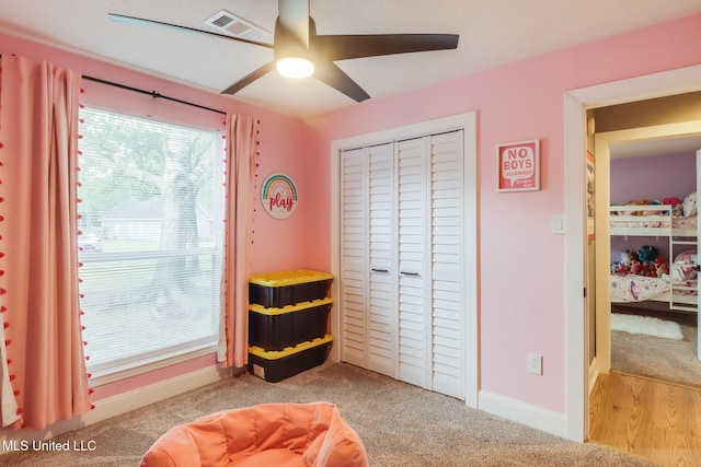 sitting room featuring ceiling fan, carpet floors, and baseboards