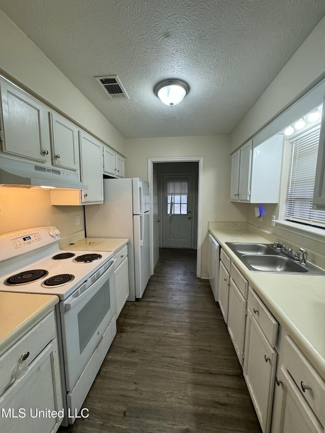 kitchen with white cabinetry, sink, white appliances, dark wood-type flooring, and a textured ceiling