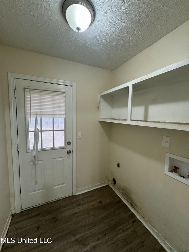 laundry room with hookup for a washing machine, dark wood-type flooring, hookup for an electric dryer, and a textured ceiling