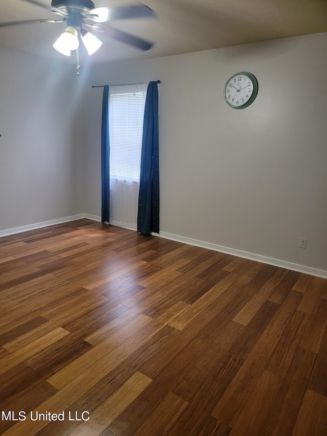 empty room with dark wood-type flooring and ceiling fan