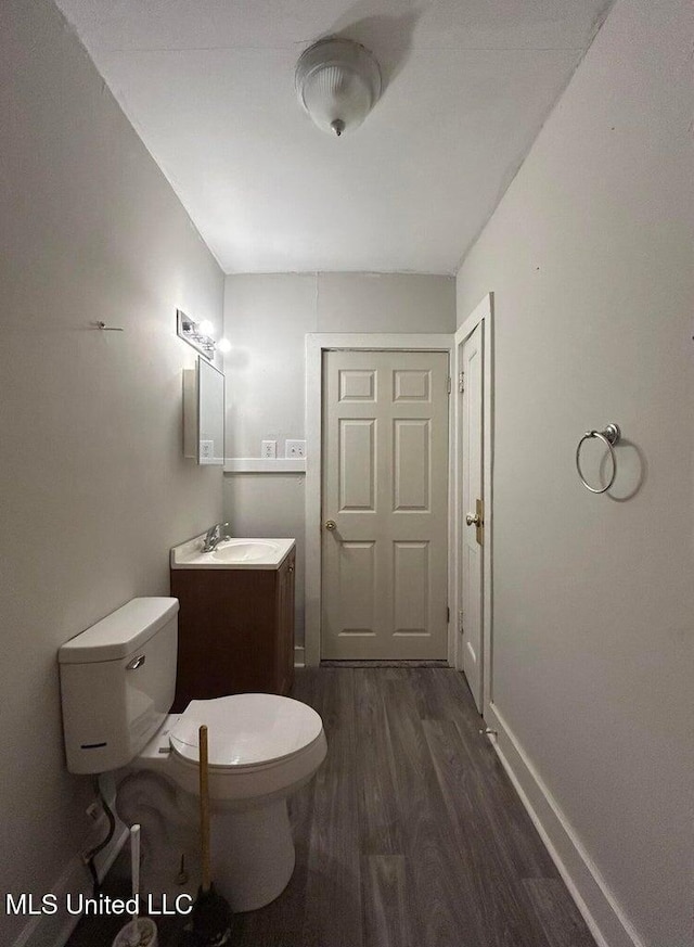 bathroom with vanity, hardwood / wood-style floors, and toilet