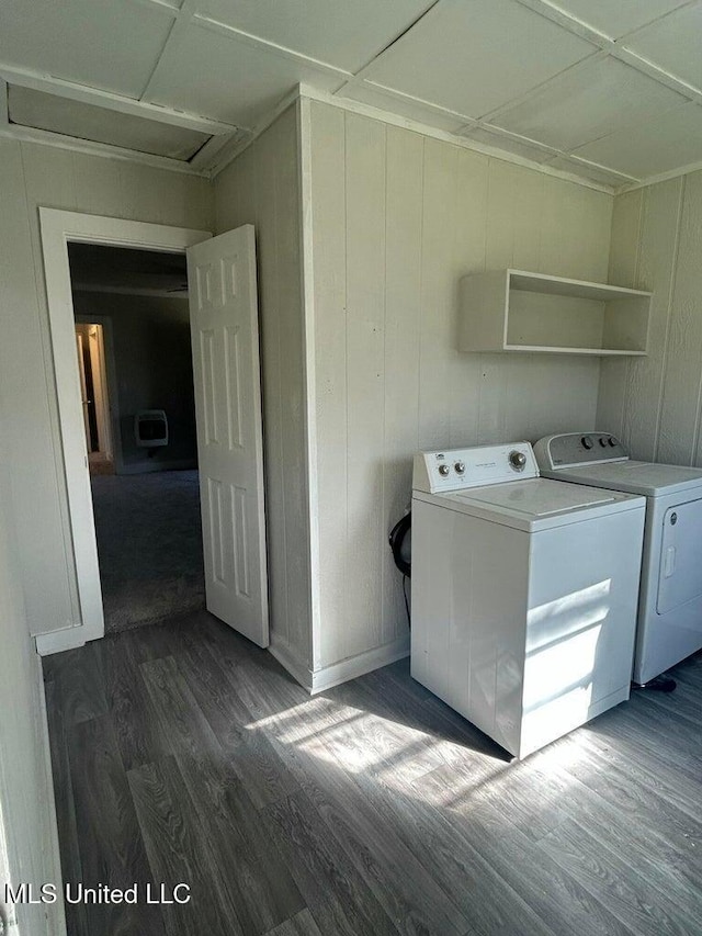 clothes washing area with heating unit, dark hardwood / wood-style floors, and washer and dryer