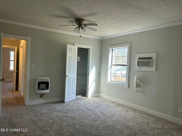 unfurnished bedroom featuring crown molding, a textured ceiling, heating unit, and an AC wall unit