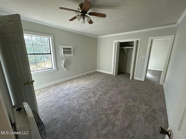 unfurnished bedroom with crown molding, ceiling fan, carpet flooring, a textured ceiling, and an AC wall unit