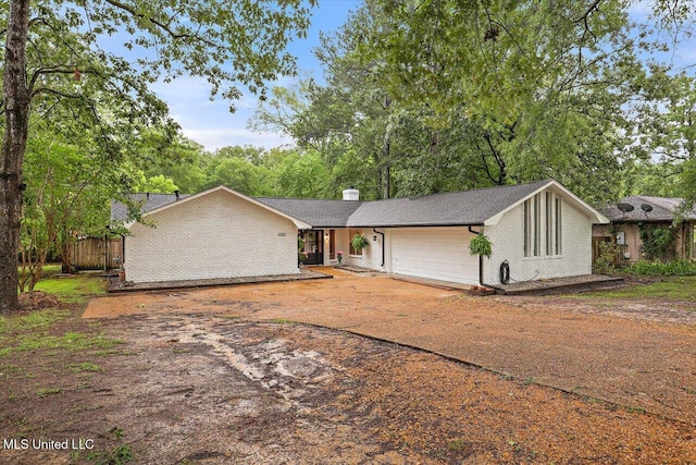 102 Holly Trl, Brandon, MS 39047 - mid-century home featuring a chimney, brick siding, and driveway