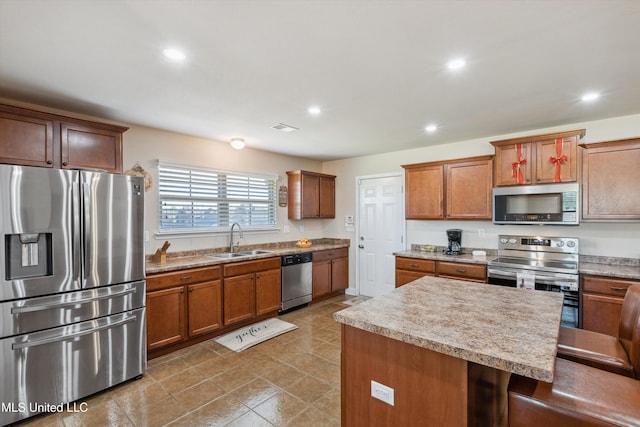 7637 Wisteria Dr, Olive Branch, MS 38654 - kitchen with a center island, a sink, light countertops, appliances with stainless steel finishes, and recessed lighting