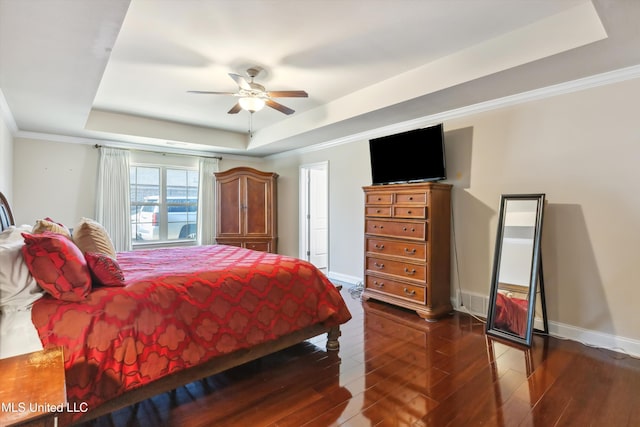 7637 Wisteria Dr, Olive Branch, MS 38654 - bedroom with baseboards, ornamental molding, a ceiling fan, dark wood-type flooring, and a raised ceiling