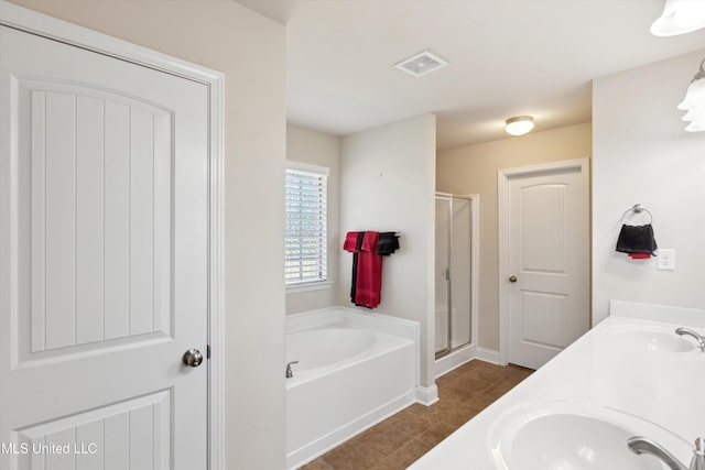 7637 Wisteria Dr, Olive Branch, MS 38654 - bathroom featuring a bath, visible vents, a sink, and a stall shower