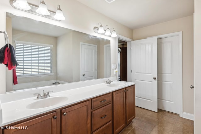 7637 Wisteria Dr, Olive Branch, MS 38654 - full bathroom featuring a sink, tile patterned floors, double vanity, and a garden tub