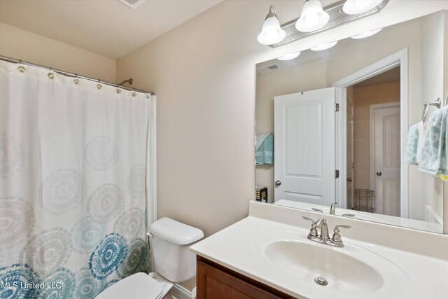 7637 Wisteria Dr, Olive Branch, MS 38654 - full bath featuring visible vents, toilet, vanity, and a shower with curtain