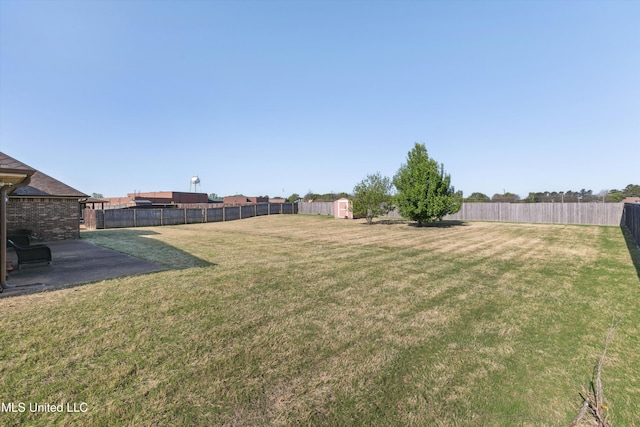 7637 Wisteria Dr, Olive Branch, MS 38654 - view of yard with a shed, a fenced backyard, and an outbuilding