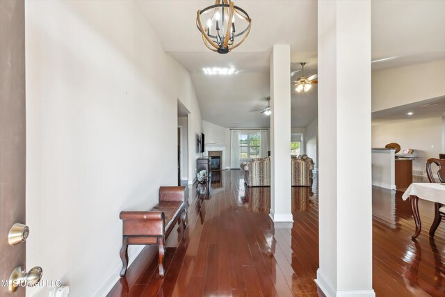 7637 Wisteria Dr, Olive Branch, MS 38654 - entryway featuring wood-type flooring, vaulted ceiling, ceiling fan with notable chandelier, and baseboards