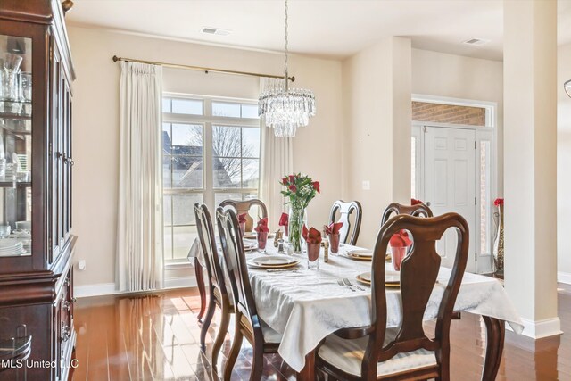 7637 Wisteria Dr, Olive Branch, MS 38654 - dining room with visible vents, baseboards, and wood finished floors