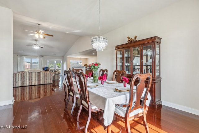 7637 Wisteria Dr, Olive Branch, MS 38654 - dining area featuring ceiling fan with notable chandelier, baseboards, dark wood finished floors, and lofted ceiling