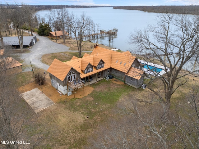 aerial view of property and surrounding area featuring a nearby body of water