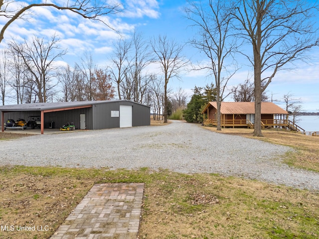 view of yard with a garage, an outdoor structure, and a carport