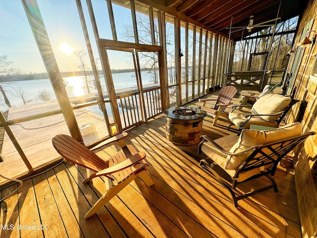 sunroom / solarium with a wealth of natural light and a water view