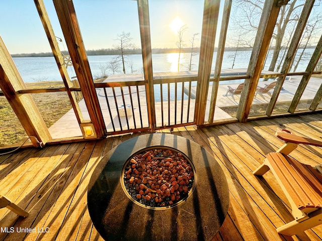 sunroom / solarium with a water view